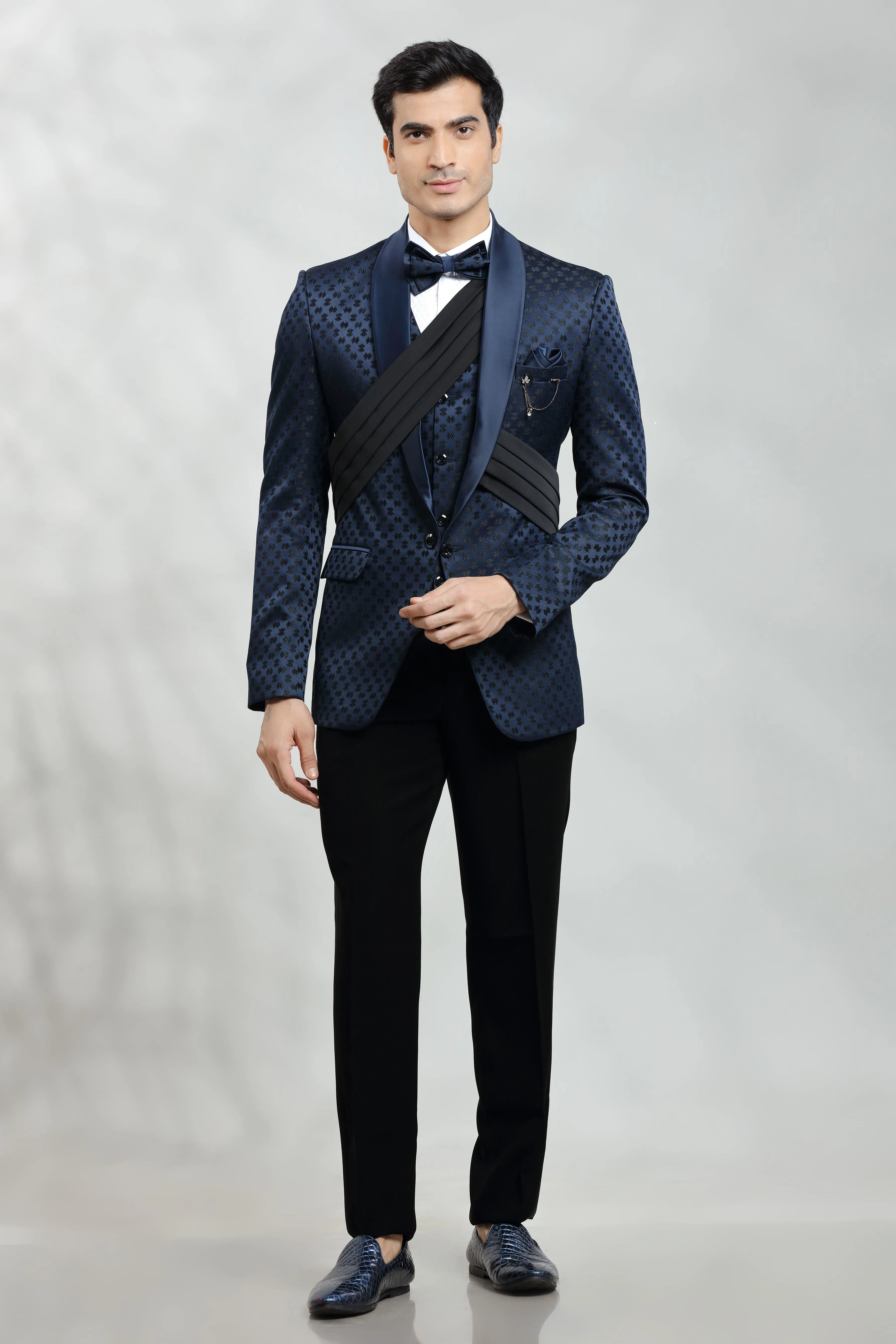 Dark blue self embroidered tuxedo with fabric pleat detail.